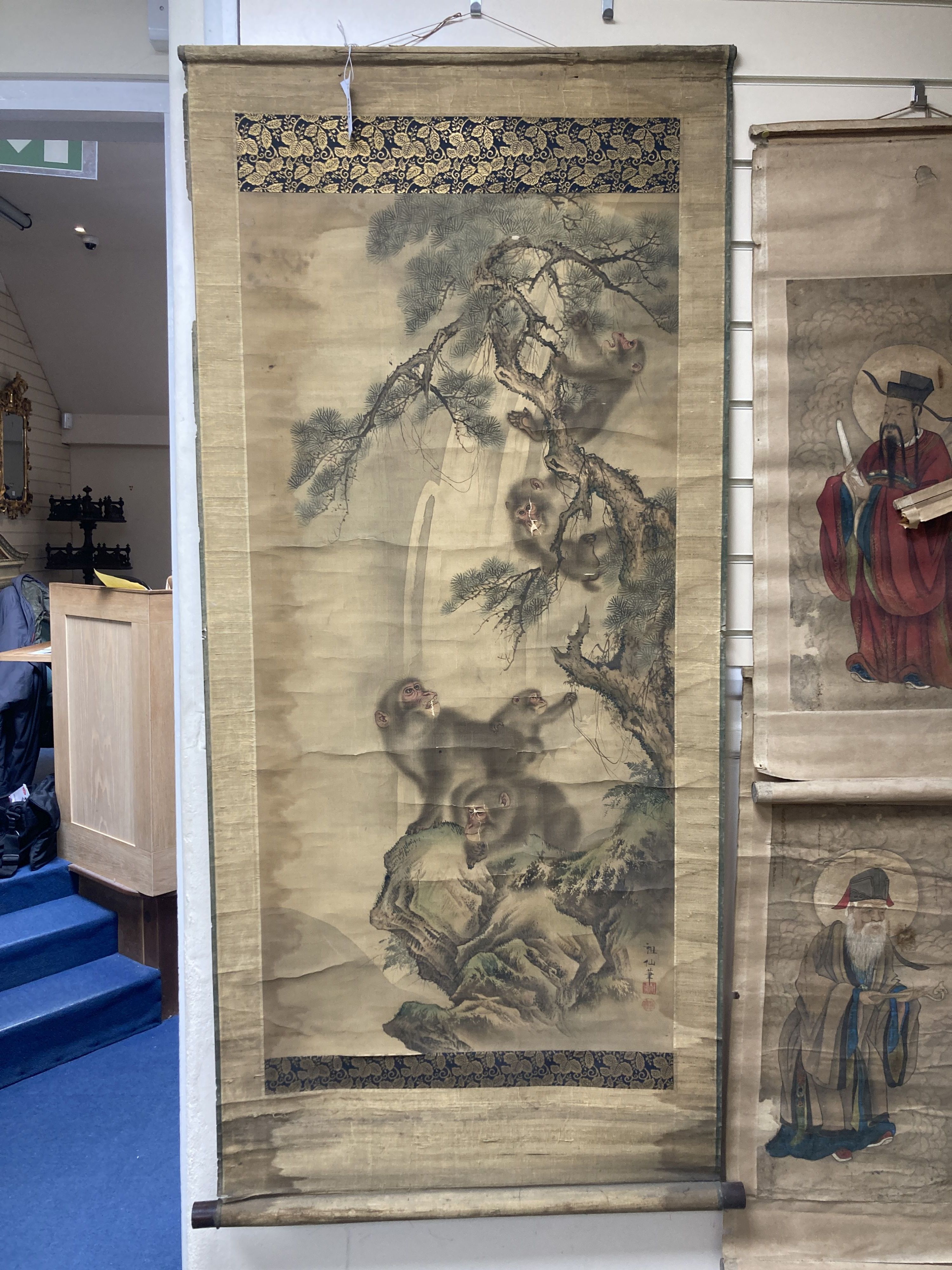 A Japanese Meiji period scroll painting on silk of monkeys amid pine trees, 113 x 55cm, some damage